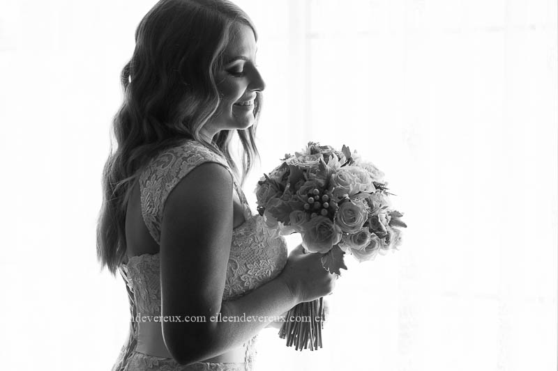 backlit bridal portrait in black and white with flowers
