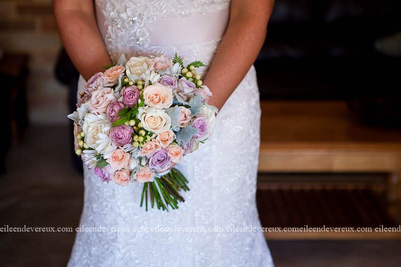 pastel pink and purple wedding bouquet with roses and lace