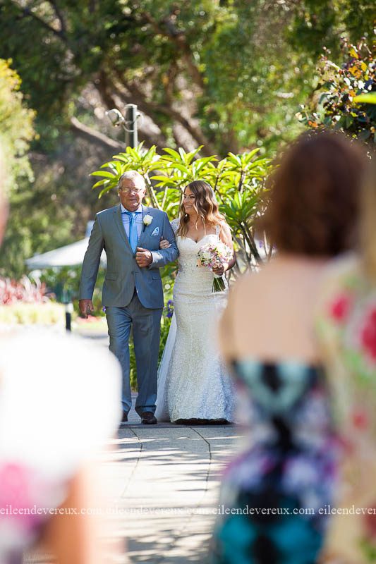 father walking daughter down the aisle, outdoor ceremony. 