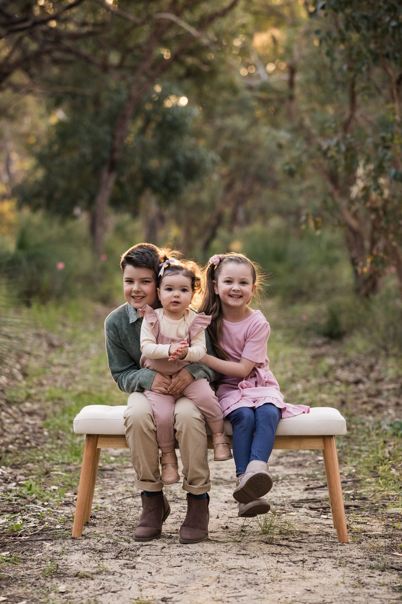 3 children sitting on a bench for family photos