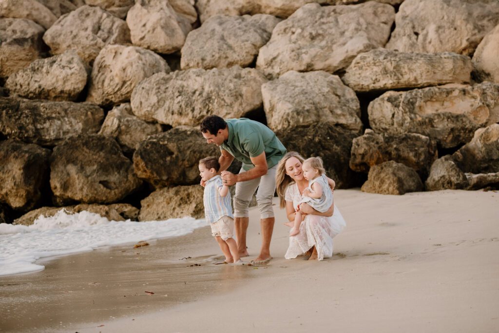 Natural family photography in Perth - parents and kids walking together on the beach