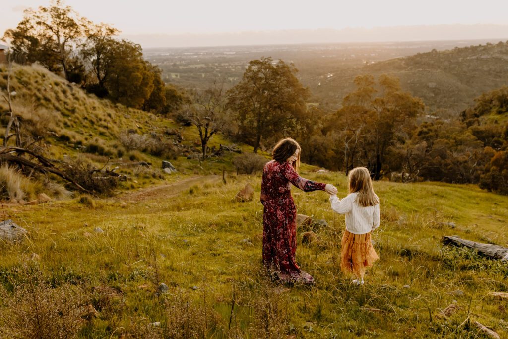 Mother has a quiet moment with her young child during a relaxed outdoor family photo session in Perth Hills preparing for a family photo session in Perth
