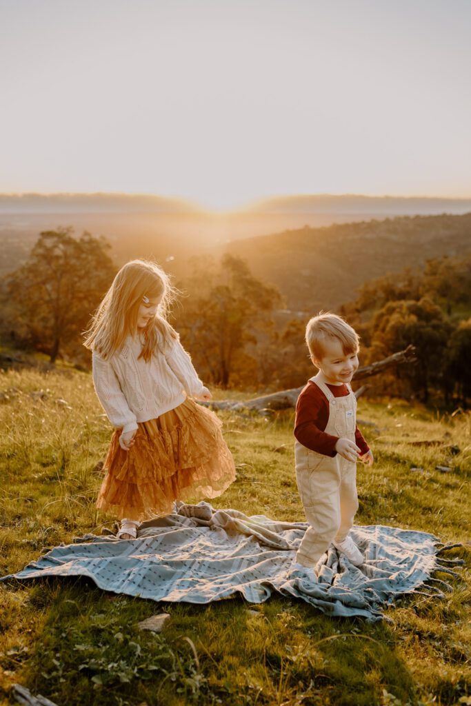 Siblings playing during a candid family photoshoot at Bells Lookout